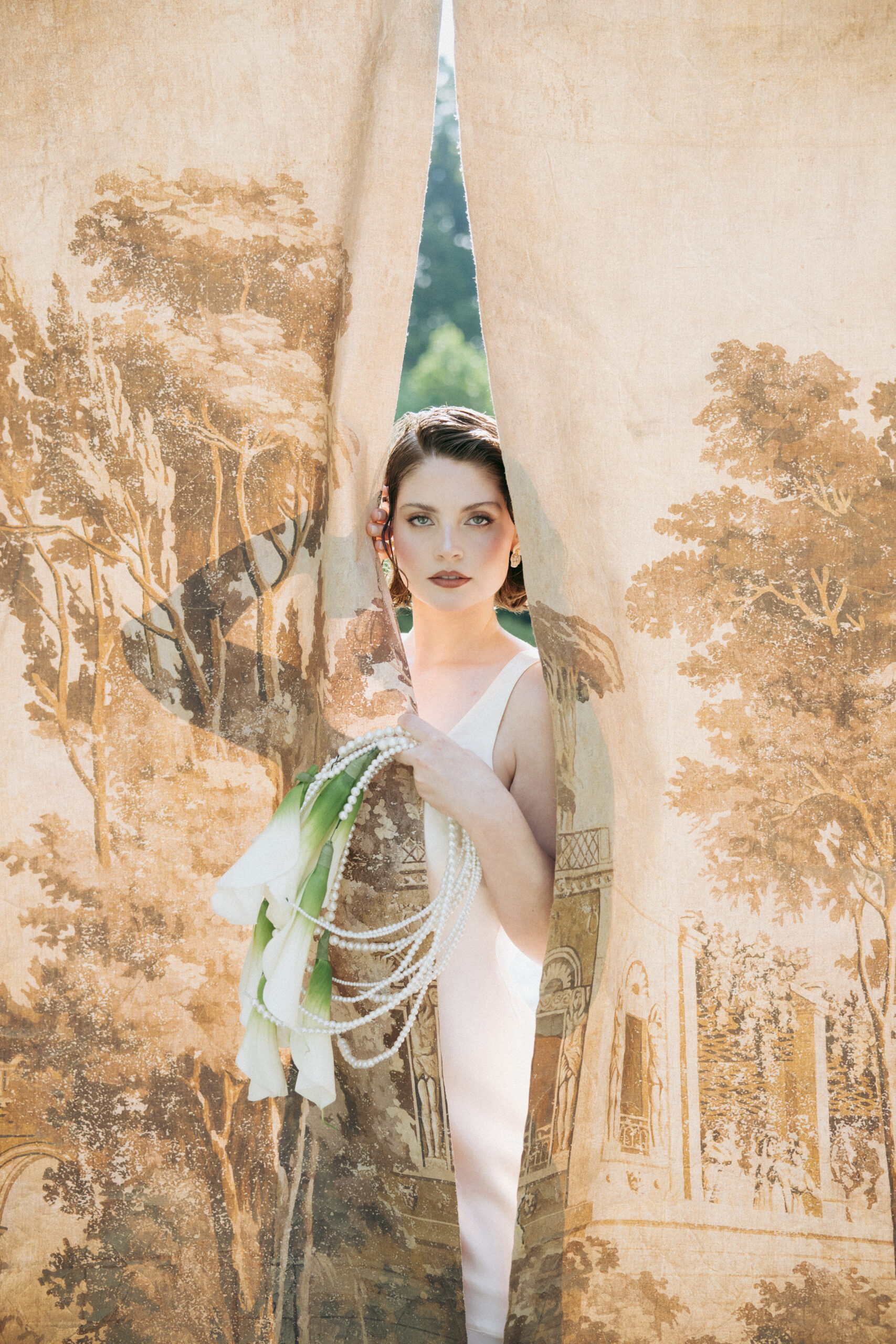 Editorial bridal at Caya Azul
Luxury bridal editorial portrait at Caya Azul wedding venue, bride styled with pearls and florals in fine art fashion photography.